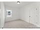 Light-filled bedroom showcasing neutral carpet, fresh paint, and a double-hung window at 810 Gondola Ct # 136P, Salisbury, NC 28144