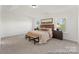 Relaxing bedroom featuring plush carpeting, a tray ceiling, and ample natural light from two windows at 810 Gondola Ct # 136P, Salisbury, NC 28144