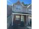 Charming townhome featuring a brick facade, complemented by neutral siding and a cozy covered porch at 9130 Charminster Ct, Charlotte, NC 28269