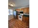 Well-lit kitchen showcasing wood cabinets and modern appliances, enhancing the cooking experience at 9130 Charminster Ct, Charlotte, NC 28269