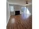 Cozy living room features wood flooring, a fireplace and sliding glass doors to the exterior at 9130 Charminster Ct, Charlotte, NC 28269