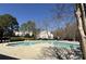 Community pool surrounded by mature trees and landscaping, offering a refreshing retreat at 9130 Charminster Ct, Charlotte, NC 28269