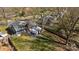 Aerial view showcases a fenced backyard with a spacious deck, mature trees offering shade, and a well-maintained lawn at 9418 Stately Oak Ln, Mint Hill, NC 28227