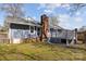 View of home backyard showing deck and chimney at 9418 Stately Oak Ln, Mint Hill, NC 28227