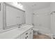 Bright bathroom featuring a large mirror, a vanity with storage, and a tub-shower combo at 9418 Stately Oak Ln, Mint Hill, NC 28227