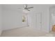 Bright bedroom featuring neutral walls, carpet flooring, a ceiling fan, and a large window at 9418 Stately Oak Ln, Mint Hill, NC 28227