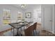 Elegant dining room featuring a modern table setting, bright windows, and stylish decor at 9418 Stately Oak Ln, Mint Hill, NC 28227