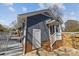 Exterior view of a charming home showcasing vertical siding and brick foundation at 9418 Stately Oak Ln, Mint Hill, NC 28227