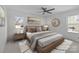 Serene main bedroom with neutral tones, a plush bed, and decorative accents for a relaxing retreat at 9418 Stately Oak Ln, Mint Hill, NC 28227