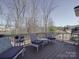 Back deck with furniture and view of treed backyard at 9786 Verdun Ct, Fort Mill, SC 29707