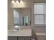 Clean bathroom featuring a single sink, quartz countertop, large mirror, and tiled floors at 9786 Verdun Ct, Fort Mill, SC 29707