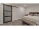 Cozy bedroom featuring a sliding barn door entrance and comfortable furnishings at 9786 Verdun Ct, Fort Mill, SC 29707