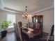 Formal dining room with elegant chandelier, wainscoting, and large window at 9786 Verdun Ct, Fort Mill, SC 29707