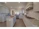 Spacious kitchen features gray cabinets, granite countertops, stainless steel appliances, and center island at 9786 Verdun Ct, Fort Mill, SC 29707