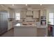 Kitchen with gray cabinetry, stainless appliances, granite countertops, and center island at 9786 Verdun Ct, Fort Mill, SC 29707