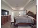 Main bedroom features tray ceilings, dark furniture, and a tv at 9786 Verdun Ct, Fort Mill, SC 29707