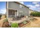 Backyard patio with outdoor dining set, fire pit, and manicured landscaping in a fenced-in yard at 1004 Whipcord Dr, Waxhaw, NC 28173