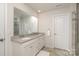 Bathroom featuring double sink vanity, a large mirror, and tiled shower with glass door at 1004 Whipcord Dr, Waxhaw, NC 28173