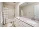 Bright bathroom featuring a double sink vanity and a shower-tub combo with a colorful shower curtain at 1004 Whipcord Dr, Waxhaw, NC 28173