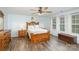 Spacious bedroom with wood flooring, ceiling fan, large window, and wooden furniture set at 1004 Whipcord Dr, Waxhaw, NC 28173