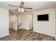 Upstairs bonus room with wood floors, ceiling fan, and wall-mounted TV at 1004 Whipcord Dr, Waxhaw, NC 28173