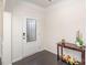 Bright entryway featuring a decorative glass door, dark wood floors, and a charming console table with floral accents at 1004 Whipcord Dr, Waxhaw, NC 28173