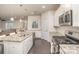 Well-lit kitchen boasting granite counters, stainless steel appliances, and a center island with a sink and dishwasher at 1004 Whipcord Dr, Waxhaw, NC 28173