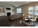 Inviting living room with a fireplace, built-in shelving, comfortable seating, and a dining area with a glass-top table at 1004 Whipcord Dr, Waxhaw, NC 28173