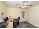 Bright home office showcasing a desk, computer setup, ceiling fan, and natural light from the window at 1004 Whipcord Dr, Waxhaw, NC 28173