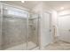 Walk-in shower with tile surround and glass door at 1004 Whipcord Dr, Waxhaw, NC 28173