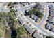 Aerial view of homes in a tranquil neighborhood with tree-lined streets and a nearby pond at 1005 Sweetleaf Dr, Fort Mill, SC 29707