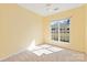 Sunny bedroom featuring neutral carpet, and a large window at 1005 Sweetleaf Dr, Fort Mill, SC 29707