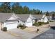 Street view of homes with manicured lawns and neatly trimmed hedges under a clear blue sky at 1005 Sweetleaf Dr, Fort Mill, SC 29707