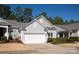 Well-maintained exterior showcasing gray siding, a two-car garage, and manicured landscaping at 1005 Sweetleaf Dr, Fort Mill, SC 29707