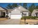 Exterior showcasing a two-car garage, neat landscaping, and a welcoming entrance at 1005 Sweetleaf Dr, Fort Mill, SC 29707