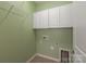 Utility room with shelving, overhead cabinets, and a tiled floor at 1005 Sweetleaf Dr, Fort Mill, SC 29707