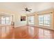 Open-concept living room with hardwood floors, a ceiling fan, and lots of natural light from the windows at 1005 Sweetleaf Dr, Fort Mill, SC 29707