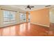 Bright living room with hardwood floors, neutral walls, and lots of natural light from large windows at 1005 Sweetleaf Dr, Fort Mill, SC 29707