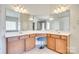 Vanity area features dual sinks, granite countertops, vanity lighting and stool at 10123 Barrands Ln, Charlotte, NC 28278