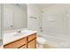 Bathroom featuring a single vanity, a shower-tub combo and tile floors at 10123 Barrands Ln, Charlotte, NC 28278