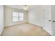 Neutral bedroom featuring a ceiling fan, large window for natural light, and plush carpeting at 10123 Barrands Ln, Charlotte, NC 28278