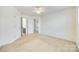 Bright bedroom featuring neutral walls, plush carpeting, and doorways to a bathroom and closet at 10123 Barrands Ln, Charlotte, NC 28278