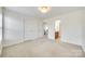 Guest bedroom with neutral carpet and decor, with view to adjoining bathroom at 10123 Barrands Ln, Charlotte, NC 28278