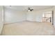 Large bedroom featuring neutral walls and carpeting, ceiling fan, and doorways to closets and upper level at 10123 Barrands Ln, Charlotte, NC 28278