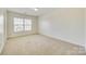 Well-lit bedroom with plush carpeting, one window, and neutral walls at 10123 Barrands Ln, Charlotte, NC 28278