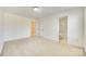 Well-lit bedroom featuring neutral walls, plush carpeting, and doorways to a bathroom and closet at 10123 Barrands Ln, Charlotte, NC 28278