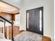 Welcoming foyer featuring a dark front door, hardwood floors, and staircase access at 10123 Barrands Ln, Charlotte, NC 28278