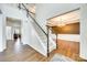 Spacious foyer with hardwood floors, staircase, and views into the living and dining rooms at 10123 Barrands Ln, Charlotte, NC 28278