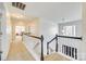 Upstairs landing with carpeted floor and staircase, featuring white trim and black banister at 10123 Barrands Ln, Charlotte, NC 28278