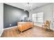 Dedicated home office with modern lighting, hardwood floors, and a sleek black accent wall at 10123 Barrands Ln, Charlotte, NC 28278